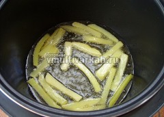 В чашу налейте масло, разогрейте в режиме жарка 5-7 минут, порционно выкладывайте картошку и обжаривайте 5-6 минут