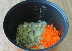 Влейте в чашу масло и выложите лук с морковью